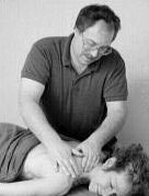 Photo of Spencer massaging a client.