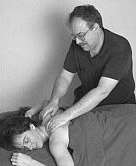 Photo of Spencer massaging a client.
