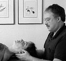 Photo of Spencer massaging a client.
